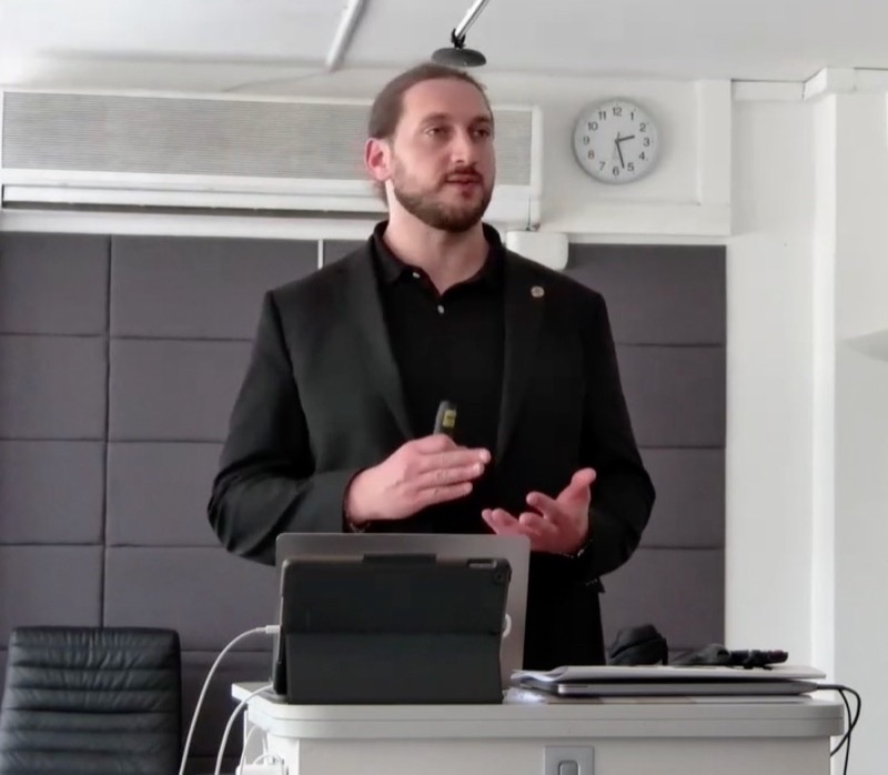 Grégory Kimpe devant le logo MHP